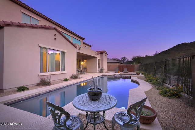 26796 N 86th Ln, Peoria, AZ 85383 - pool at dusk with a fenced backyard, a fenced in pool, and a patio area