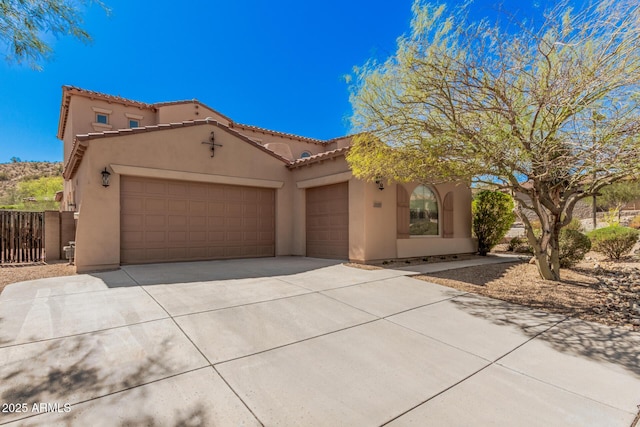 26796 N 86th Ln, Peoria, AZ 85383 - mediterranean / spanish-style house featuring driveway, stucco siding, fence, an attached garage, and a tiled roof