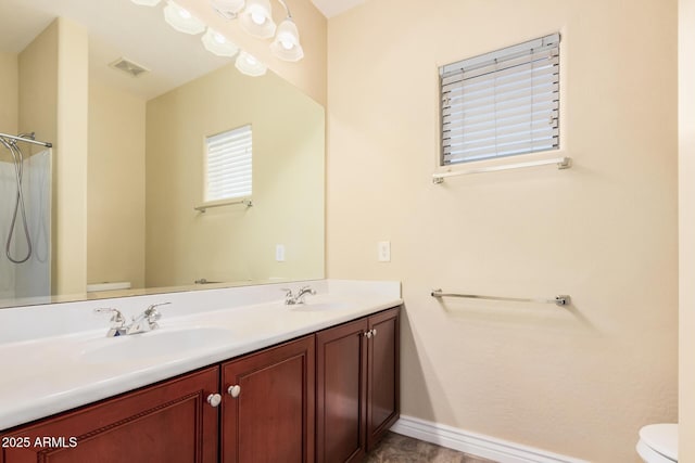 26796 N 86th Ln, Peoria, AZ 85383 - bathroom with double vanity, visible vents, toilet, and a sink