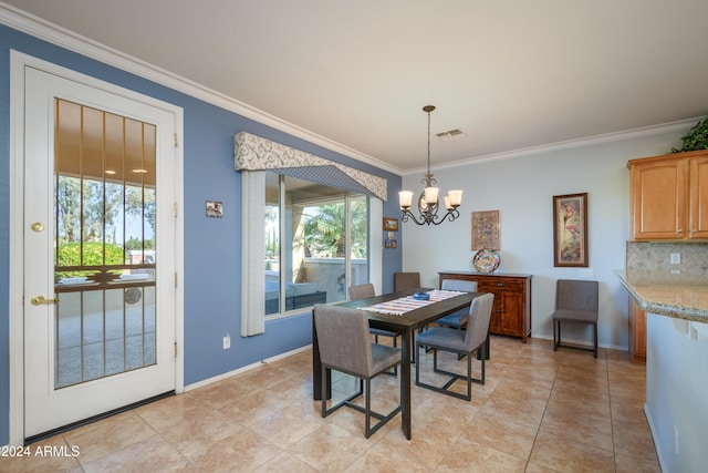 tiled dining room featuring an inviting chandelier and ornamental molding