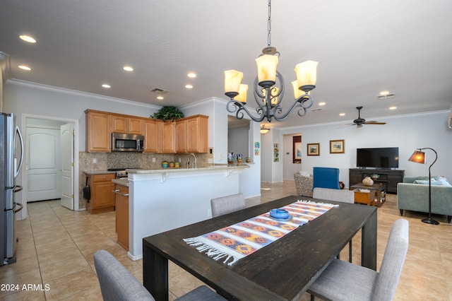 dining room with ceiling fan with notable chandelier, sink, ornamental molding, and light tile patterned flooring