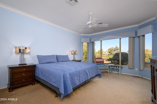 carpeted bedroom featuring ceiling fan and ornamental molding