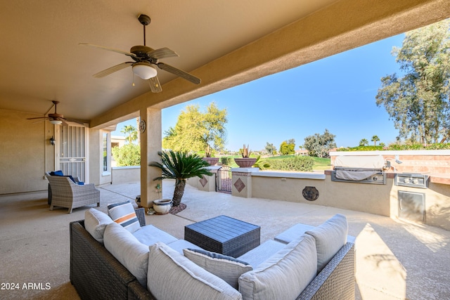 view of patio with ceiling fan, exterior kitchen, and an outdoor hangout area