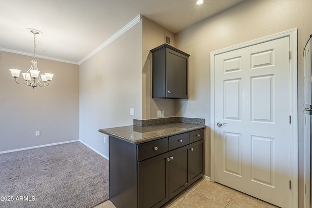 5345 E Van Buren St Unit 305, Phoenix, AZ 85008 - kitchen featuring crown molding, a chandelier, baseboards, and hanging light fixtures