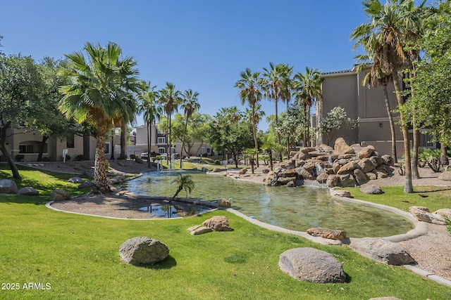 5345 E Van Buren St Unit 305, Phoenix, AZ 85008 - view of community with a lawn and a small pond
