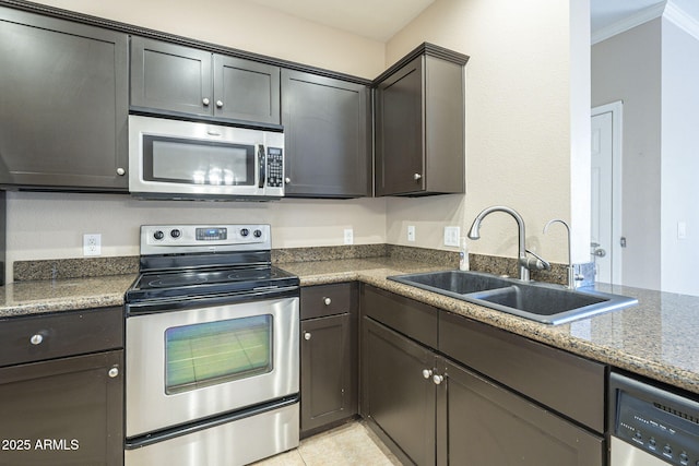 5345 E Van Buren St Unit 305, Phoenix, AZ 85008 - kitchen with appliances with stainless steel finishes, a sink, and light tile patterned floors