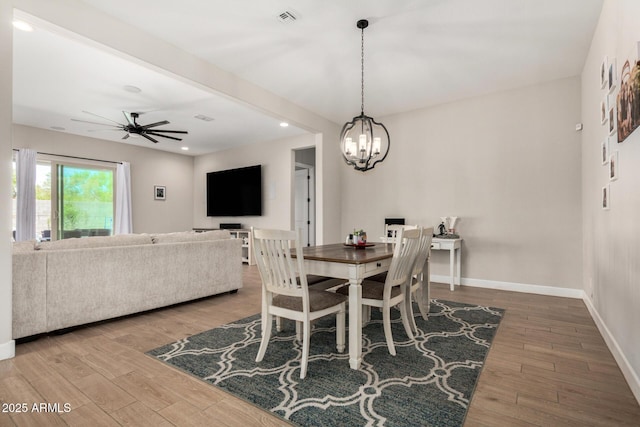5314 N 182nd Ln, Litchfield Park, AZ 85340 - dining area featuring a chandelier, wood finished floors, ceiling fan, and recessed lighting