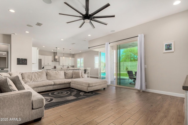 5314 N 182nd Ln, Litchfield Park, AZ 85340 - living room featuring wood finished floors, a ceiling fan, and recessed lighting