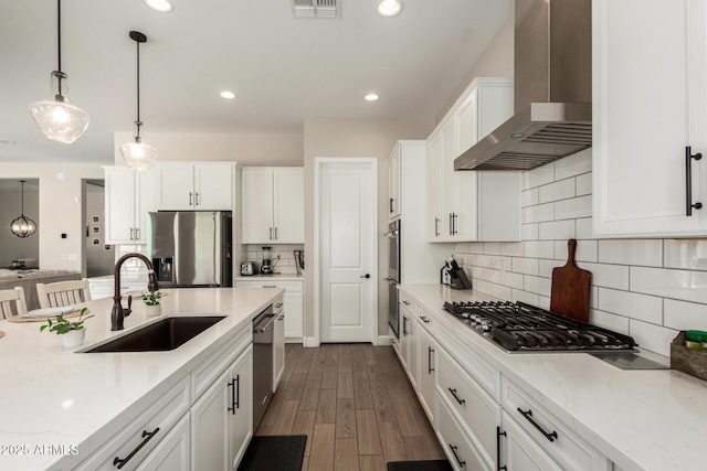 5314 N 182nd Ln, Litchfield Park, AZ 85340 - kitchen featuring wall chimney range hood, stainless steel appliances, white cabinetry, decorative light fixtures, and dark wood-style floors