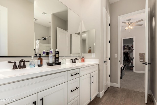 5314 N 182nd Ln, Litchfield Park, AZ 85340 - full bath with double vanity, a ceiling fan, wood finished floors, a shower with curtain, and a spacious closet
