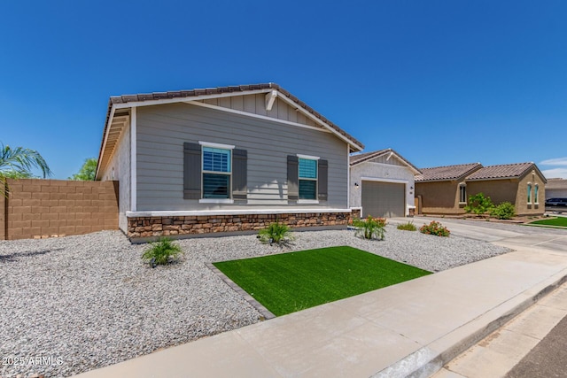 5314 N 182nd Ln, Litchfield Park, AZ 85340 - view of front facade featuring an attached garage, driveway, and stone siding
