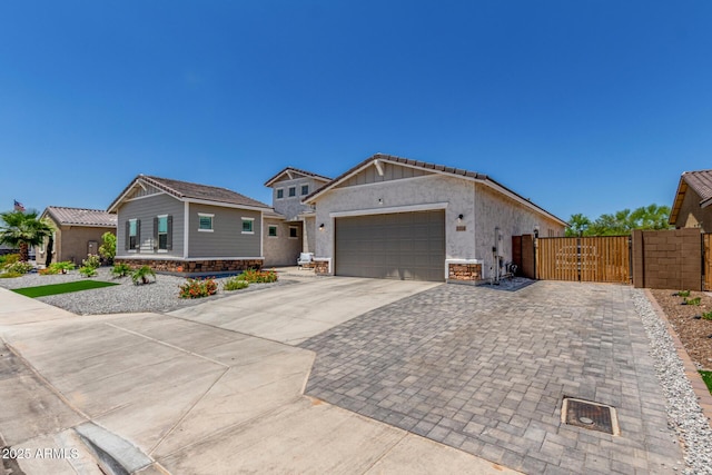 5314 N 182nd Ln, Litchfield Park, AZ 85340 - view of front of house with a gate, driveway, a garage, stone siding, and stucco siding