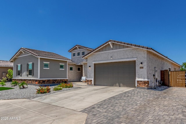 5314 N 182nd Ln, Litchfield Park, AZ 85340 - view of front facade featuring concrete driveway, a garage, stone siding, and a gate