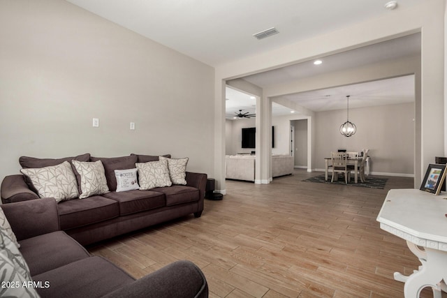 5314 N 182nd Ln, Litchfield Park, AZ 85340 - living room featuring light wood-type flooring, a ceiling fan, recessed lighting, and a chandelier