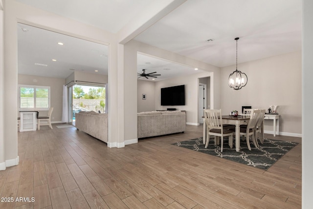 5314 N 182nd Ln, Litchfield Park, AZ 85340 - dining space with wood finished floors, a chandelier, a ceiling fan, and recessed lighting