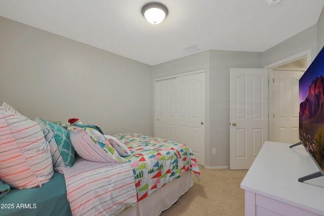 bedroom with light carpet and a closet