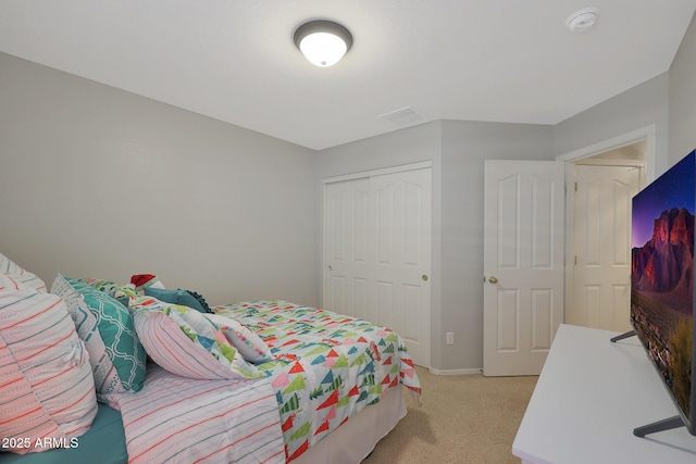 bedroom with light colored carpet and a closet