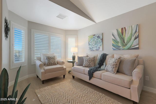 living room with light wood-type flooring and lofted ceiling