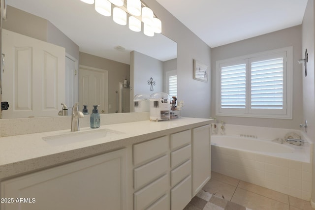 bathroom featuring vanity, a relaxing tiled tub, and tile patterned floors