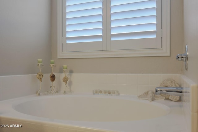 bathroom with tiled tub and a wealth of natural light