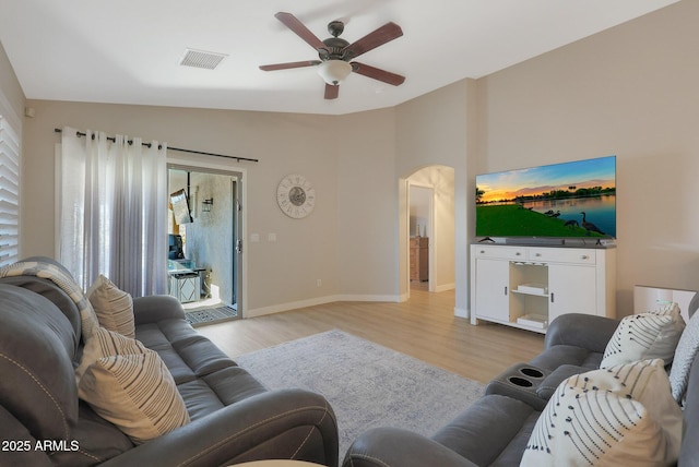 living room with ceiling fan, a healthy amount of sunlight, light hardwood / wood-style flooring, and lofted ceiling