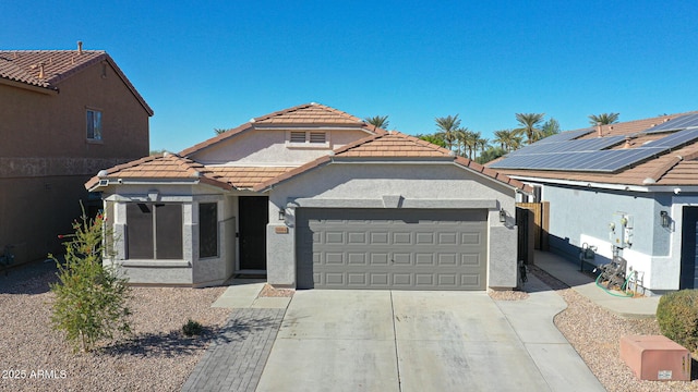 view of front of home with a garage and solar panels