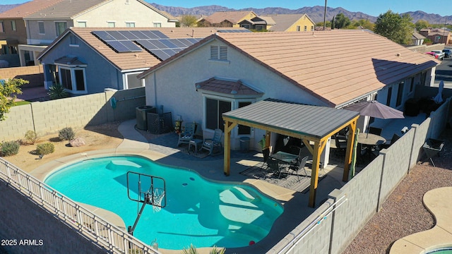 view of swimming pool with a mountain view and a patio area