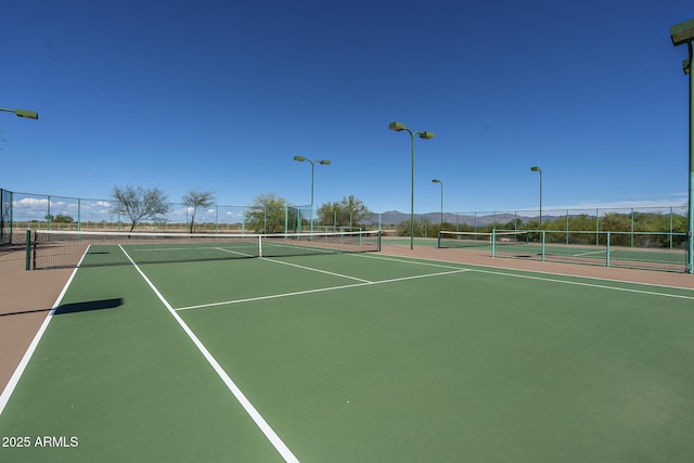 view of tennis court featuring basketball court