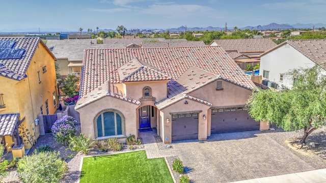 710 W Ardmore Rd, Phoenix, AZ 85041 - view of front of property featuring stucco siding, a garage, decorative driveway, a mountain view, and a tile roof