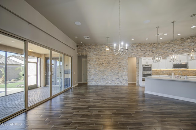 710 W Ardmore Rd, Phoenix, AZ 85041 - unfurnished living room featuring dark wood-type flooring, a chandelier, recessed lighting, and a sink
