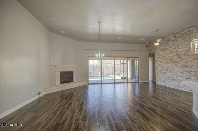 710 W Ardmore Rd, Phoenix, AZ 85041 - unfurnished living room with dark wood-style floors, a tile fireplace, a chandelier, and baseboards