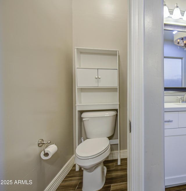 710 W Ardmore Rd, Phoenix, AZ 85041 - bathroom featuring toilet, wood finished floors, vanity, and baseboards