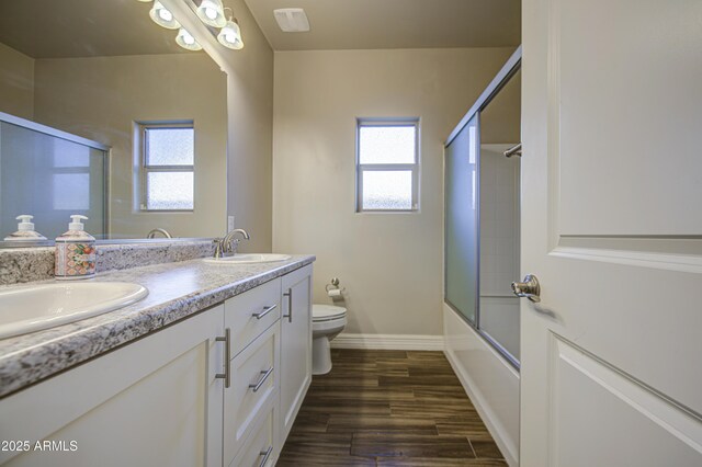 710 W Ardmore Rd, Phoenix, AZ 85041 - full bath featuring toilet, double vanity, bath / shower combo with glass door, and healthy amount of natural light