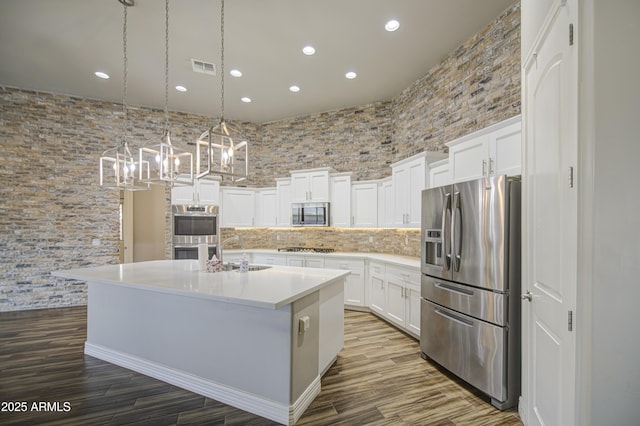 710 W Ardmore Rd, Phoenix, AZ 85041 - kitchen with stainless steel appliances, recessed lighting, a sink, a chandelier, and white cabinetry