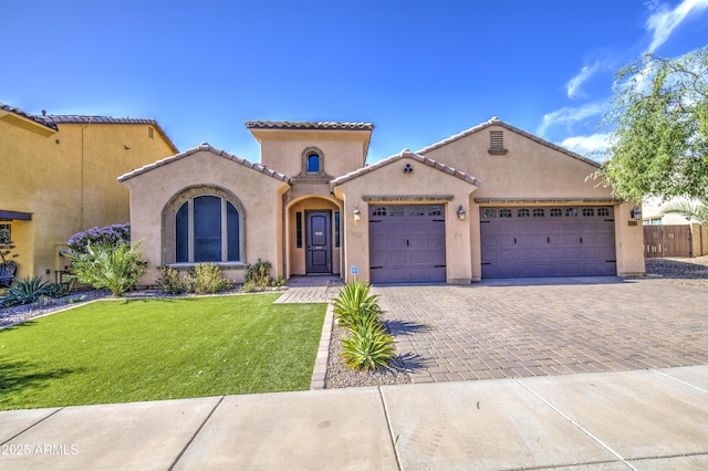 710 W Ardmore Rd, Phoenix, AZ 85041 - mediterranean / spanish house featuring decorative driveway, an attached garage, stucco siding, and a tile roof