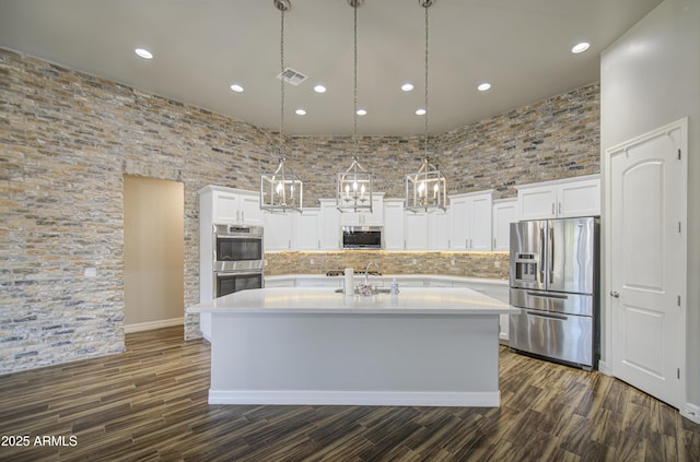 710 W Ardmore Rd, Phoenix, AZ 85041 - kitchen with stainless steel appliances, an island with sink, white cabinets, light countertops, and recessed lighting
