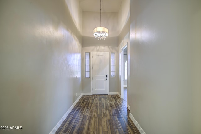710 W Ardmore Rd, Phoenix, AZ 85041 - foyer entrance featuring a chandelier, dark wood finished floors, baseboards, and a towering ceiling