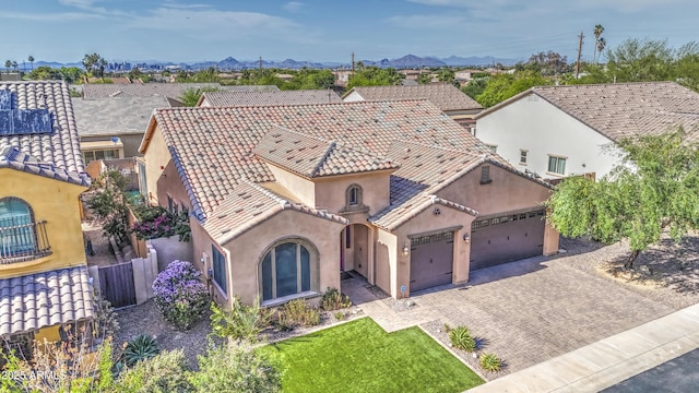 710 W Ardmore Rd, Phoenix, AZ 85041 - mediterranean / spanish home featuring stucco siding, an attached garage, decorative driveway, a mountain view, and a tiled roof
