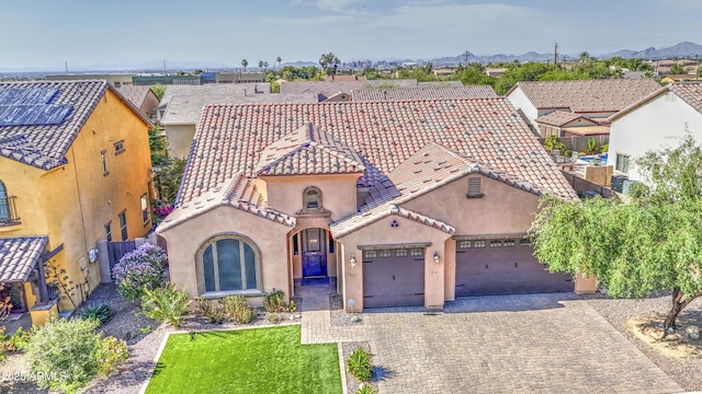 710 W Ardmore Rd, Phoenix, AZ 85041 - view of front facade with a garage, stucco siding, decorative driveway, a tiled roof, and a residential view