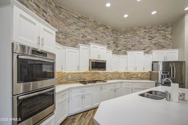 710 W Ardmore Rd, Phoenix, AZ 85041 - kitchen with appliances with stainless steel finishes, a sink, light countertops, recessed lighting, and white cabinetry