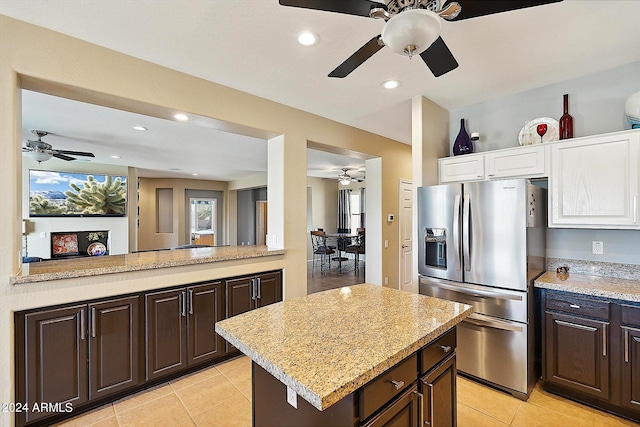 kitchen with ceiling fan, dark brown cabinets, stainless steel refrigerator with ice dispenser, and light tile floors