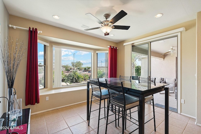 dining space with ceiling fan and light tile floors