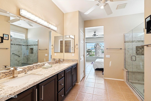 bathroom with plenty of natural light, double sink, and walk in shower