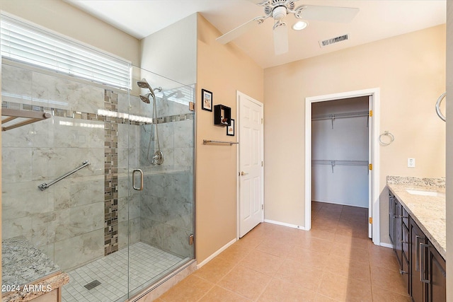 bathroom with vanity, a shower with door, tile floors, and ceiling fan