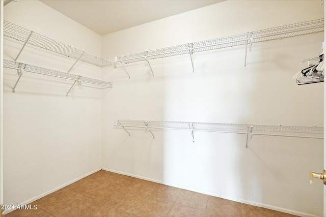 spacious closet featuring light tile flooring