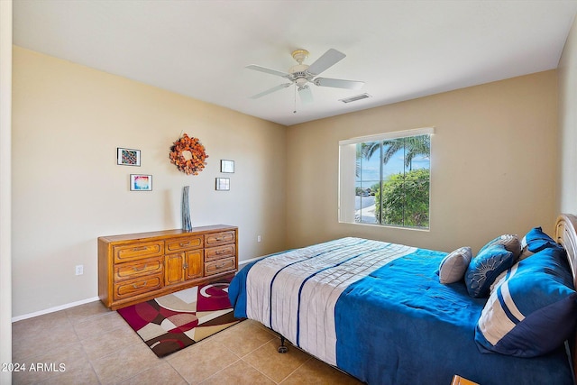 tiled bedroom featuring ceiling fan