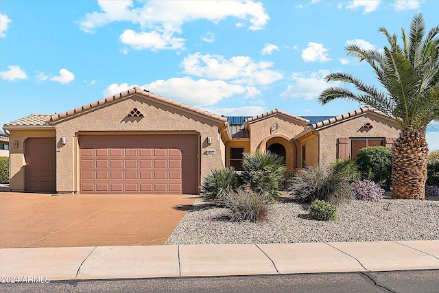 mediterranean / spanish-style home featuring a garage