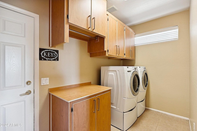 washroom with cabinets, light tile flooring, and independent washer and dryer