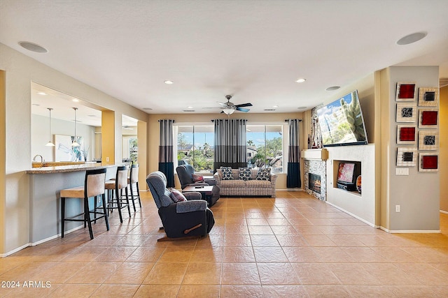 tiled living room featuring ceiling fan