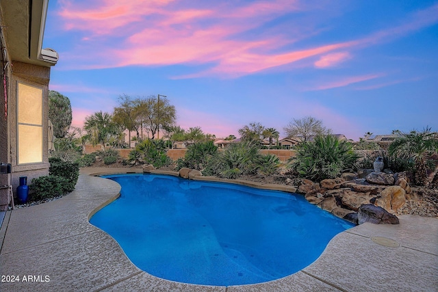 view of pool at dusk